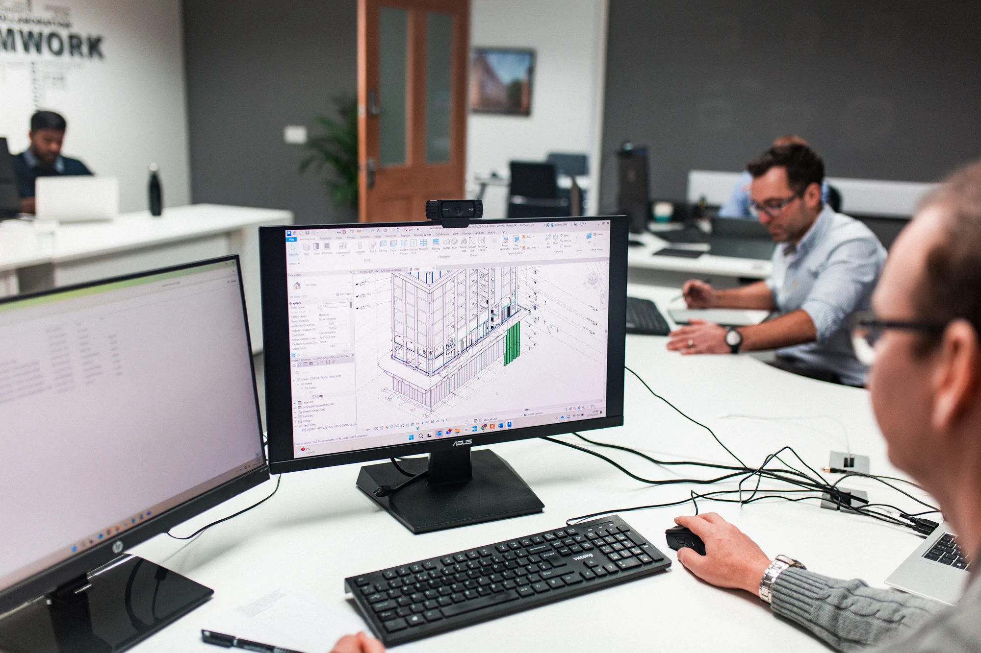 CLW waterproofing consultants reviewing basement design drawings in the studio