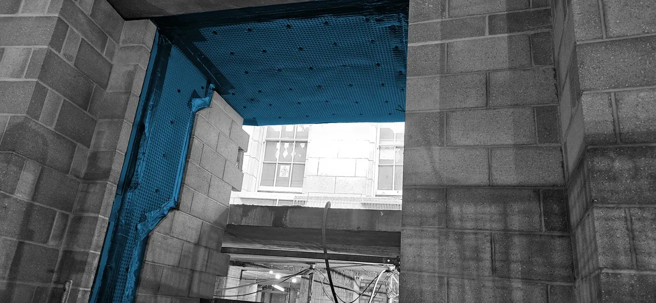 Waterproofing membrane dressed around a structural opening in a masonry basement wall